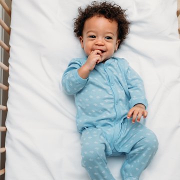 Happy baby in a crib